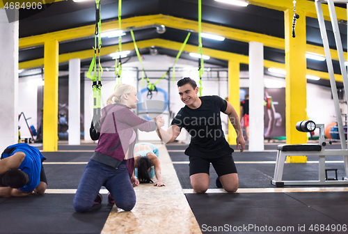 Image of young healthy people doing pushups