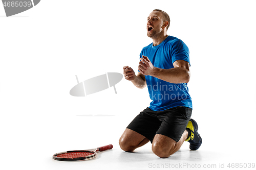 Image of Portrait of a handsome male tennis player celebrating his success isolated on a white background