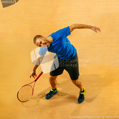 Image of Tennis player crouching down looking defeated and sad