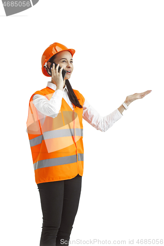 Image of The female builder in orange helmet isolated on white