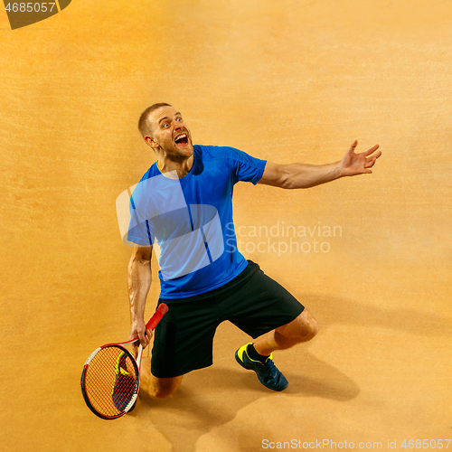 Image of Portrait of a handsome male tennis player celebrating his success at court