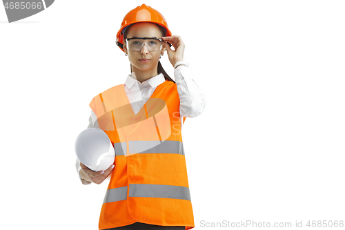 Image of The female builder in orange helmet isolated on white