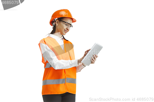 Image of The female builder in orange helmet isolated on white