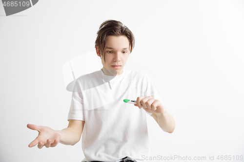 Image of Upset man looking in pregnancy test. Frustrated model