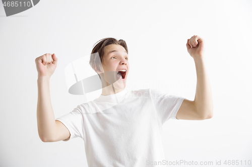 Image of Winning success man happy ecstatic celebrating being a winner. Dynamic energetic image of male model