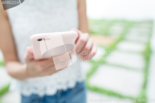 Image of Woman sending sms on cellphone