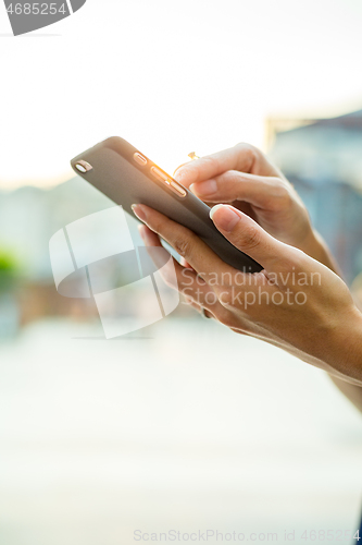 Image of Woman sending sms on cellphone