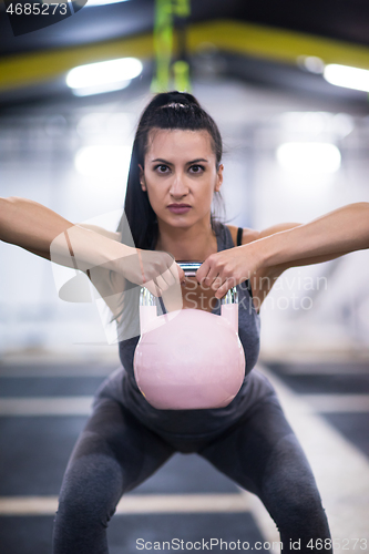 Image of woman exercise with fitness kettlebell