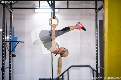 Image of woman working out on gymnastic rings