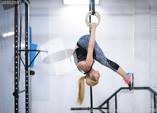 Image of woman working out on gymnastic rings