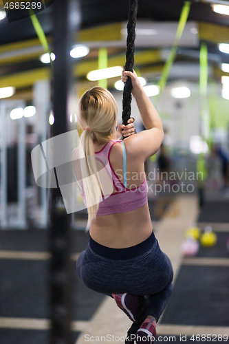 Image of woman doing rope climbing