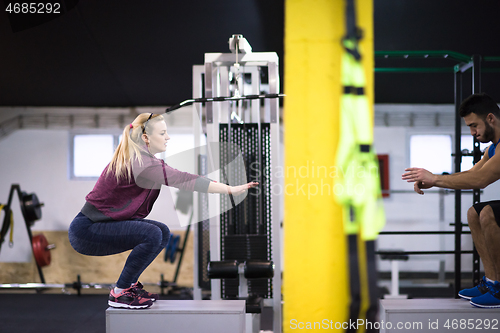 Image of athletes working out  jumping on fit box