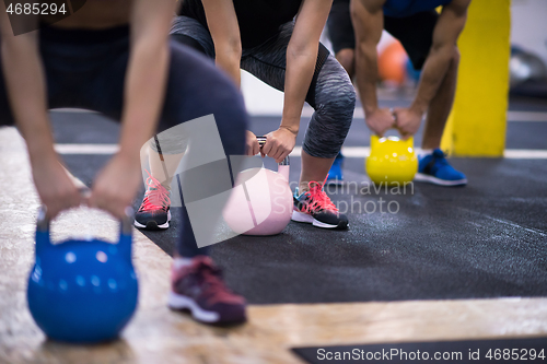 Image of athletes doing exercises with kettlebells