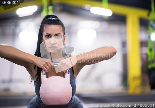 Image of woman exercise with fitness kettlebell