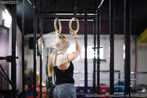 Image of woman working out on gymnastic rings