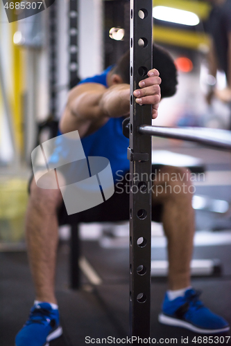 Image of man doing pull ups on the vertical bar