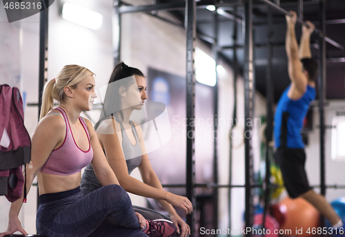 Image of young athletes doing pull ups on the horizontal bar