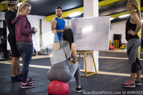 Image of athletes getting instructions from trainer