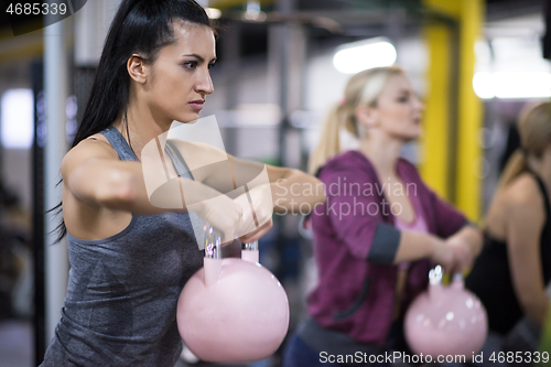 Image of athletes doing exercises with kettlebells