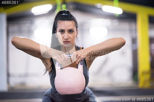 Image of woman exercise with fitness kettlebell