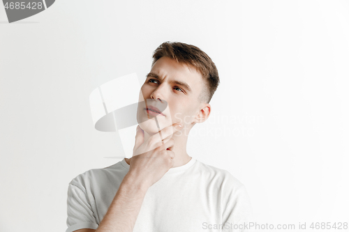 Image of Young dreaming man isolated on white background looking at something