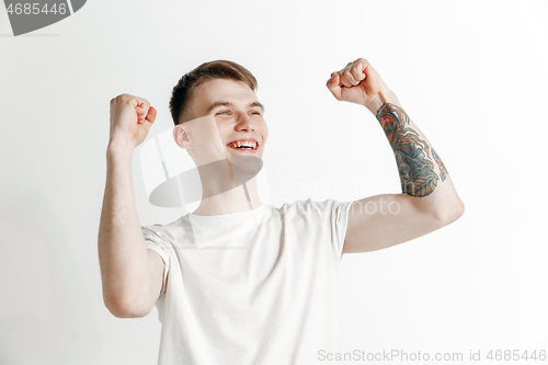 Image of Winning success man happy ecstatic celebrating being a winner. Dynamic energetic image of male model