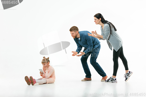 Image of Angry parents scolding their daughter at home