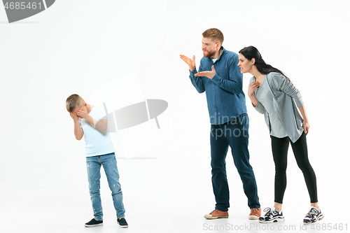 Image of Angry parents scolding their son at home