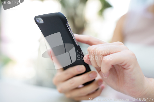 Image of Woman sending sms on phone