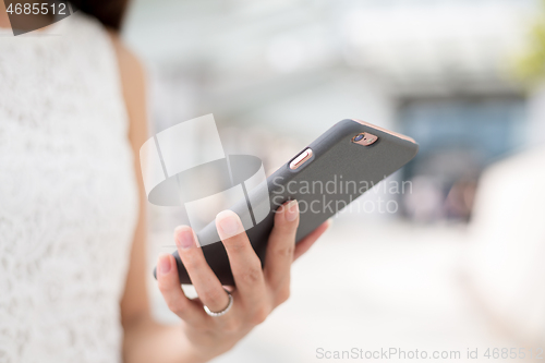 Image of Woman sending message on phone