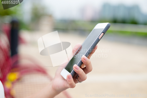 Image of Woman sending sms on cellphone