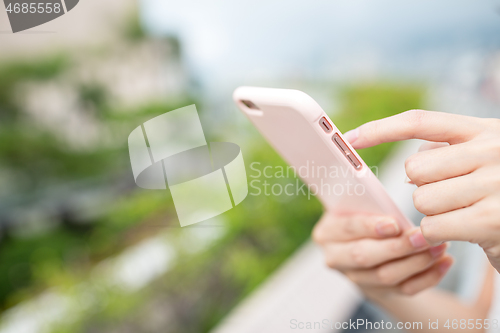 Image of Woman use of cellphone at outdoor