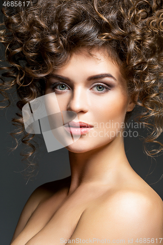 Image of beautiful girl with curly hairdo