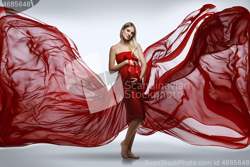 Image of Pregnant girl in red dress