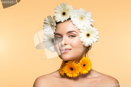 Image of beautiful girl with white and yellow flowers 