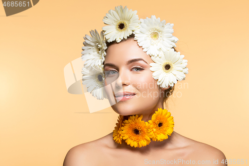 Image of beautiful girl with white and yellow flowers 