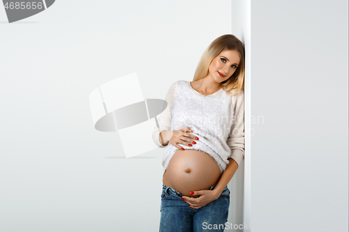 Image of Beautiful pregnant woman in jeans
