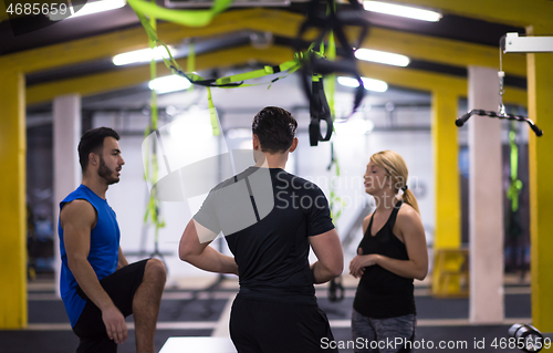 Image of athletes working out  jumping on fit box