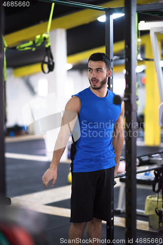 Image of man doing pull ups on the vertical bar