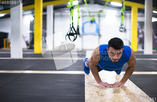 Image of Young  man doing pushups