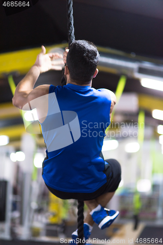 Image of man doing rope climbing