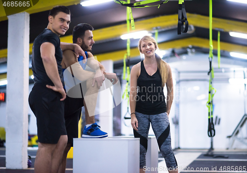 Image of athletes working out  jumping on fit box