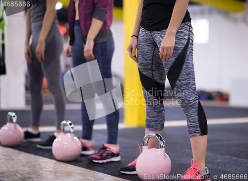 Image of athletes doing exercises with kettlebells