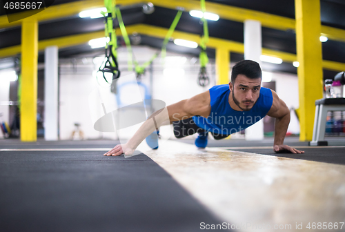 Image of Young  man doing pushups