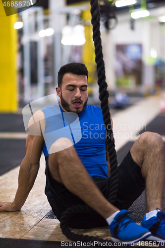 Image of man relaxing before rope climbing