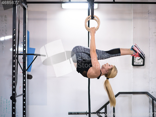 Image of woman working out on gymnastic rings