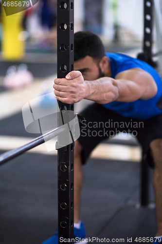 Image of man doing pull ups on the vertical bar