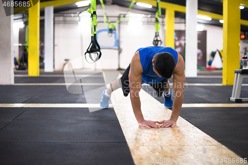 Image of Young  man doing pushups