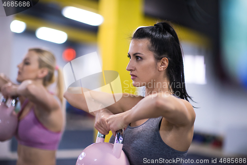 Image of athletes doing exercises with kettlebells