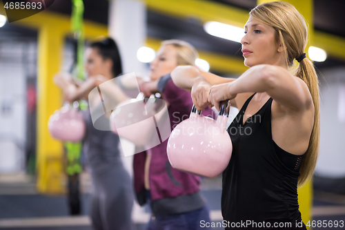 Image of athletes doing exercises with kettlebells